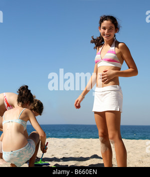 Three teen girls playing on the beach