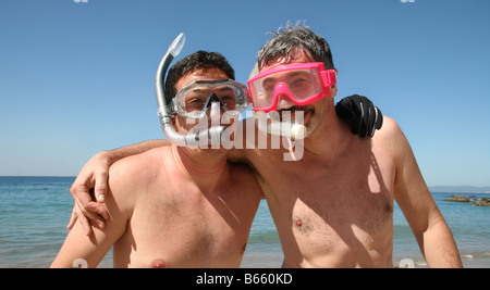 Two men are about to go snorkeling in the ocean Stock Photo