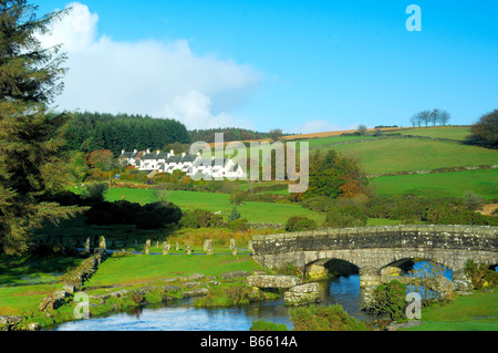 Bellever in Devon with a modern bridge crossing the East Dart River besides the remains of the ancient clapper bridge Stock Photo