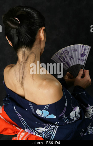 Japanese Woman in a Blue Kimono with a Fan Stock Photo