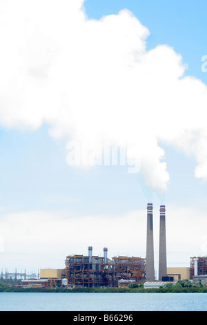 Smoke stack at an electrical plant billowing smoke Stock Photo