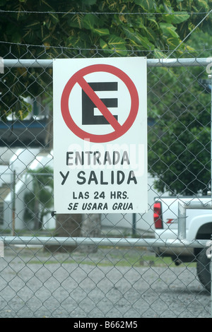 A no parking sign in spanish on a fence in Mexico Stock Photo