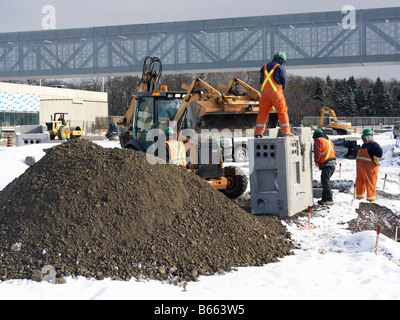 construction workers on a job site in winter Stock Photo