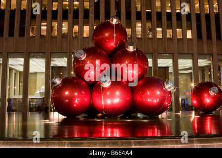 Big red balls as ornaments for the Christmas tree as an art exhibit on 6th Avenue in New York City Stock Photo