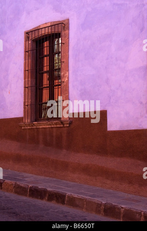 Colorful purple walls and ornate window detail on street in San Miguel de Allende Mexico Stock Photo