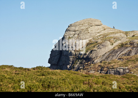 The Face of Haytor with two people walking on top Dartmoor Devon Stock Photo
