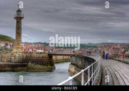 Whitby North Yorkshire England pier and harbour walls in HDR with tourists looking and taking photos Stock Photo