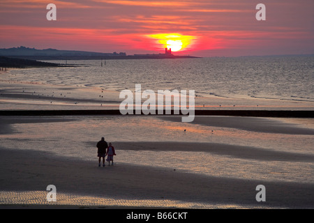 Sunset behind Reculver Towers from Minnis Bay Birchington [Isle of Thanet] Kent England Stock Photo