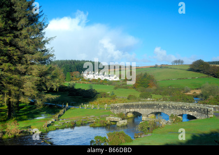 Bellever in Devon with a modern bridge crossing the East dart River besides the remains of the ancient clapper bridge Stock Photo