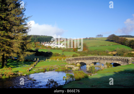 Bellever in Devon with a modern bridge crossing the East dart River besides the remains of the ancient clapper bridge Stock Photo