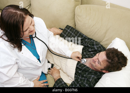 Overhead view of a home health nurse using stethoscope to listen to her patient s heart Room for text Stock Photo