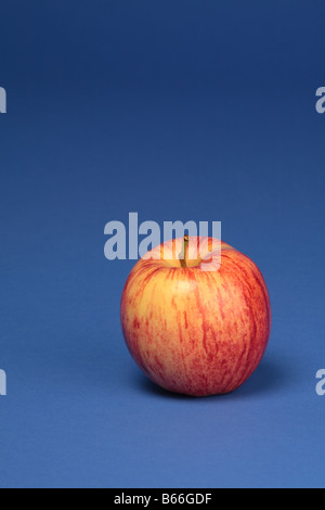 An apple on a blue background. Stock Photo