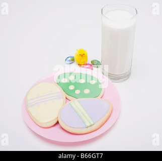Glass of milk and Easter cookies Stock Photo