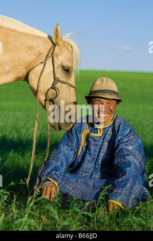 A Mongol herdsman with his herd of horses in the vast Mongolian ...