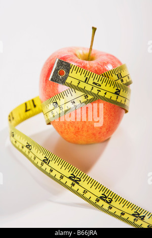 Tape measure wrapped around red apple Stock Photo