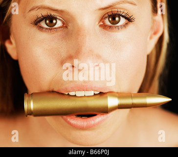 Biting The Bullet Stock Photo - Alamy