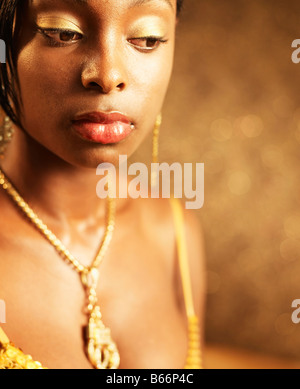 Portrait of Woman Wearing Gold Jewelry Stock Photo