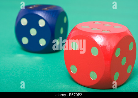 Red and blue dice on green background Stock Photo