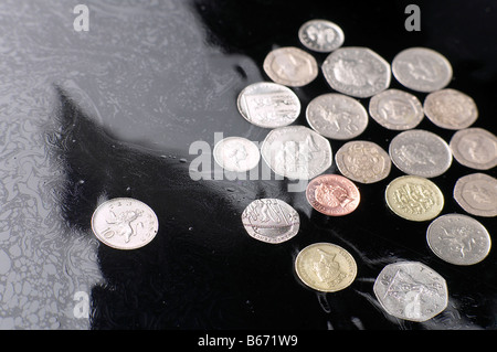 BRITISH MONEY SINKING IN MURKY WATERS Stock Photo