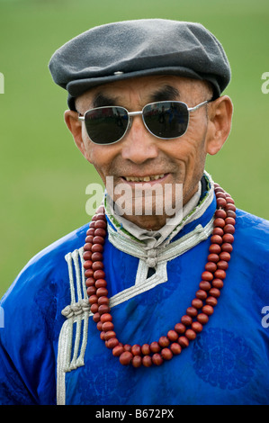 Traditionally dressed ethnic Mongolian attends summertime Naadam Festival Xiwuzhumuqinqi Inner Mongolia China Stock Photo