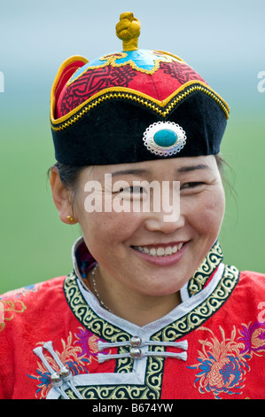 Traditionally dressed ethnic Mongolian attends summertime Naadam Festival Xiwuzhumuqinqi Inner Mongolia China Stock Photo