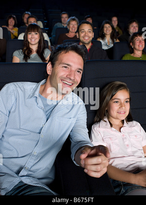 A father and daughter watching a movie Stock Photo