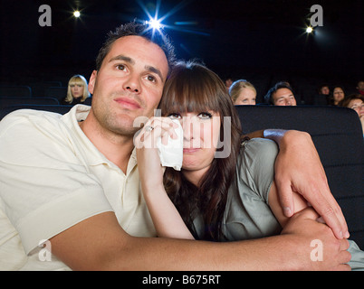 A man comforting a woman watching a sad movie Stock Photo