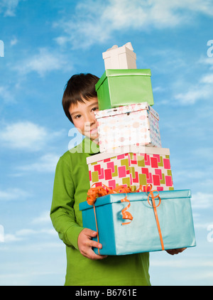 A boy carrying presents Stock Photo