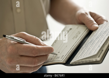 A man holding a cheque book Stock Photo