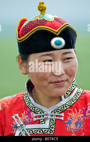 Traditionally dressed ethnic Mongolian attends summertime Naadam Festival Xiwuzhumuqinqi Inner Mongolia China Stock Photo