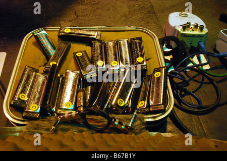 case with harmonicas and sound equipment on stage at rock concert Stock Photo
