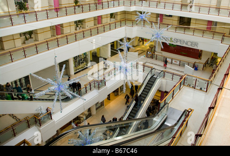 The Belfry Shopping Centre Mall with escalators at Christmas Redhill Surrey Stock Photo
