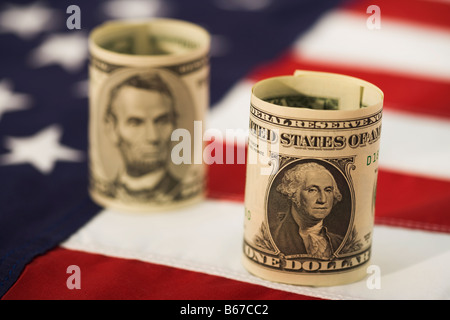 One dollar and five dollar bills on American flag, close-up Stock Photo