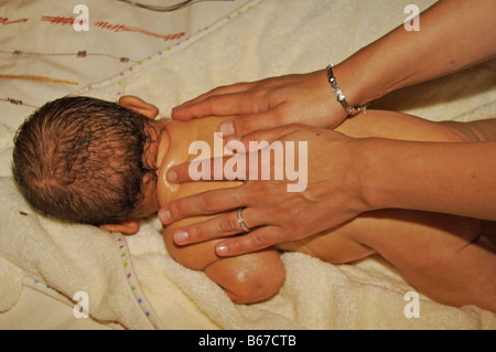 Baby boy being massaged Stock Photo