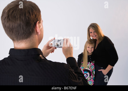 Man taking picture woman and girl (8-9) Stock Photo