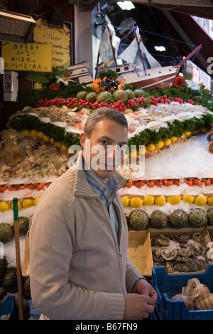 Restaurateur prepares pavement display of shellfish and seafood on ice outside a seafood restaurant in Brussels. Belgium. (44) Stock Photo