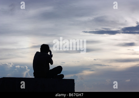 A boy taking a picture of a dramatic sky. Stock Photo