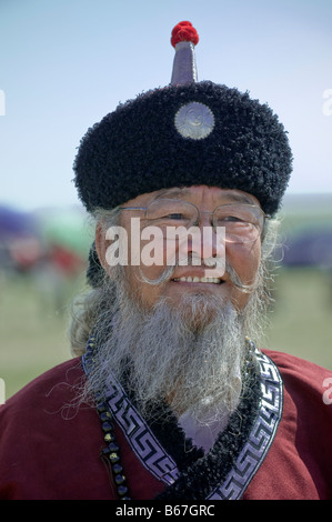 Traditionally dressed ethnic Mongolian attends summertime Naadam Festival Xiwuzhumuqinqi Inner Mongolia China Stock Photo