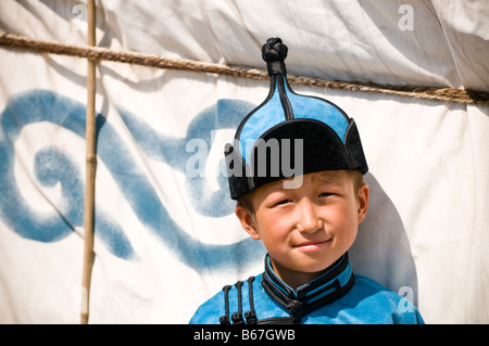 Traditionally dressed ethnic Mongolian child attends summertime Naadam Festival Xiwuzhumuqinqi Inner Mongolia China Stock Photo