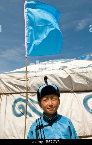 Traditionally dressed ethnic Mongolian child attends summertime Naadam Festival Xiwuzhumuqinqi Inner Mongolia China Stock Photo