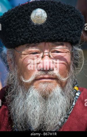 Traditionally dressed ethnic Mongolian attends summertime Naadam Festival Xiwuzhumuqinqi Inner Mongolia China Stock Photo