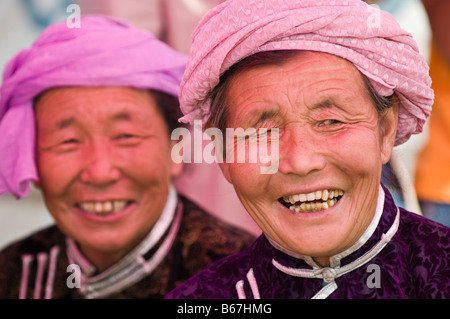 Traditionally dressed ethnic Mongolians attends summertime Naadam Festival Xiwuzhumuqinqi Inner Mongolia China Stock Photo