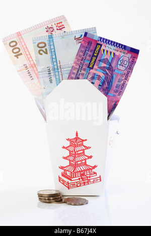 Paper currency in a donation box with coins Stock Photo