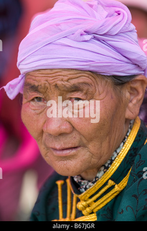 Traditionally dressed ethnic Mongolian attends summertime Naadam Festival Xiwuzhumuqinqi Inner Mongolia China Stock Photo