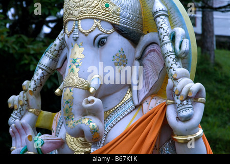 Head and shoulder detail of a colourful statue of the Hindu God - The Lord Ganesh, - God of good luck, wisdom and success. Stock Photo