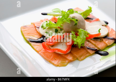 Close-up of salmon dish with palmito and soy sauce Stock Photo