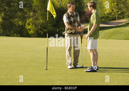 Male Golfers Shaking Hands Stock Photo