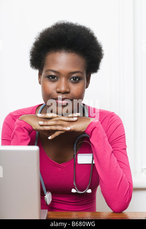 Physician Sitting Behind Desk Stock Photo