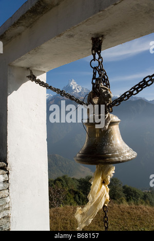 Fishtail Mountain and bell from Baraha Buddhist temple above Ghandruk village in the Annapurna range, Himalayas, Nepal Stock Photo