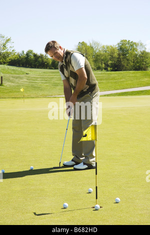Man Practicing on Putting Green Stock Photo